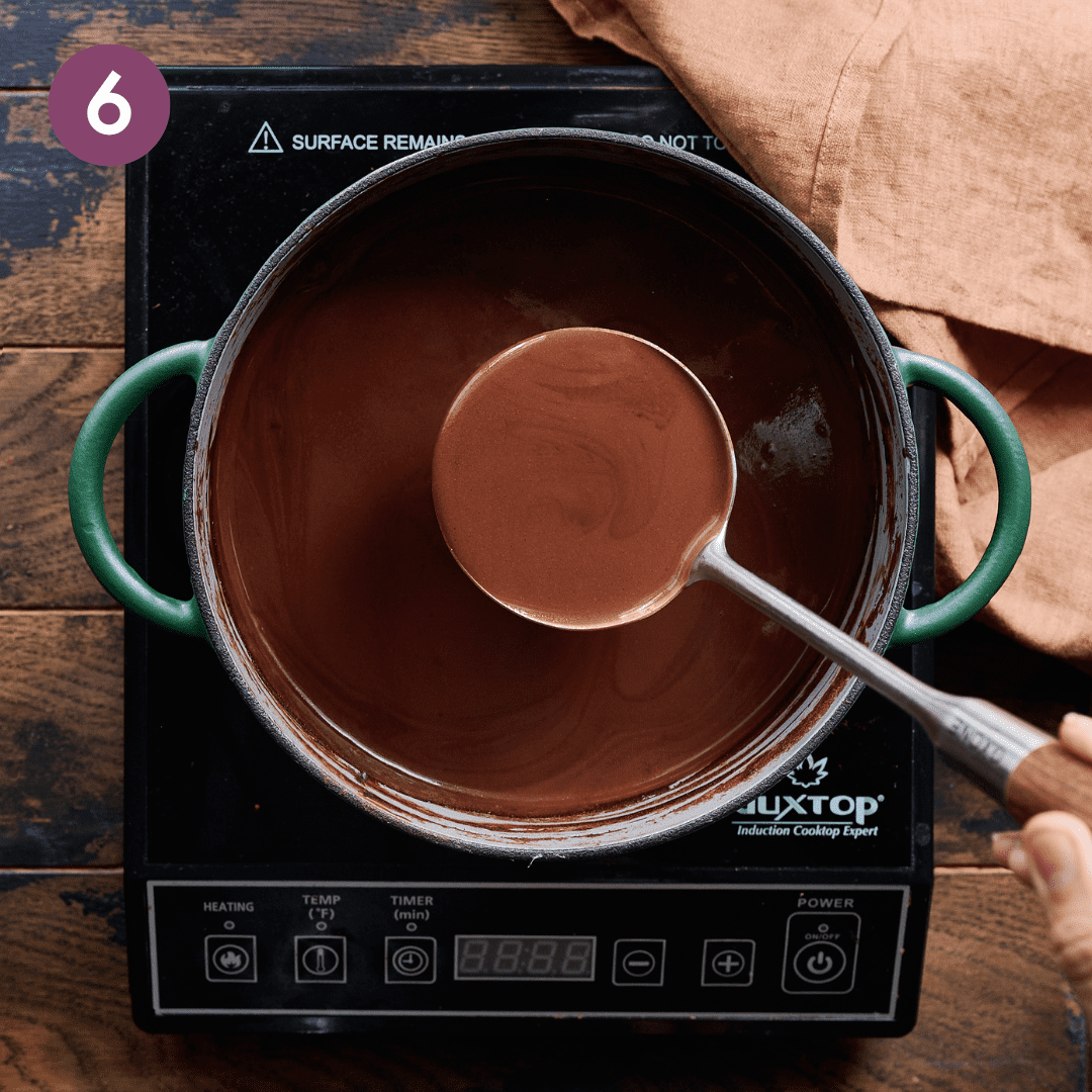 Creamy hot chocolate mixture in pot.